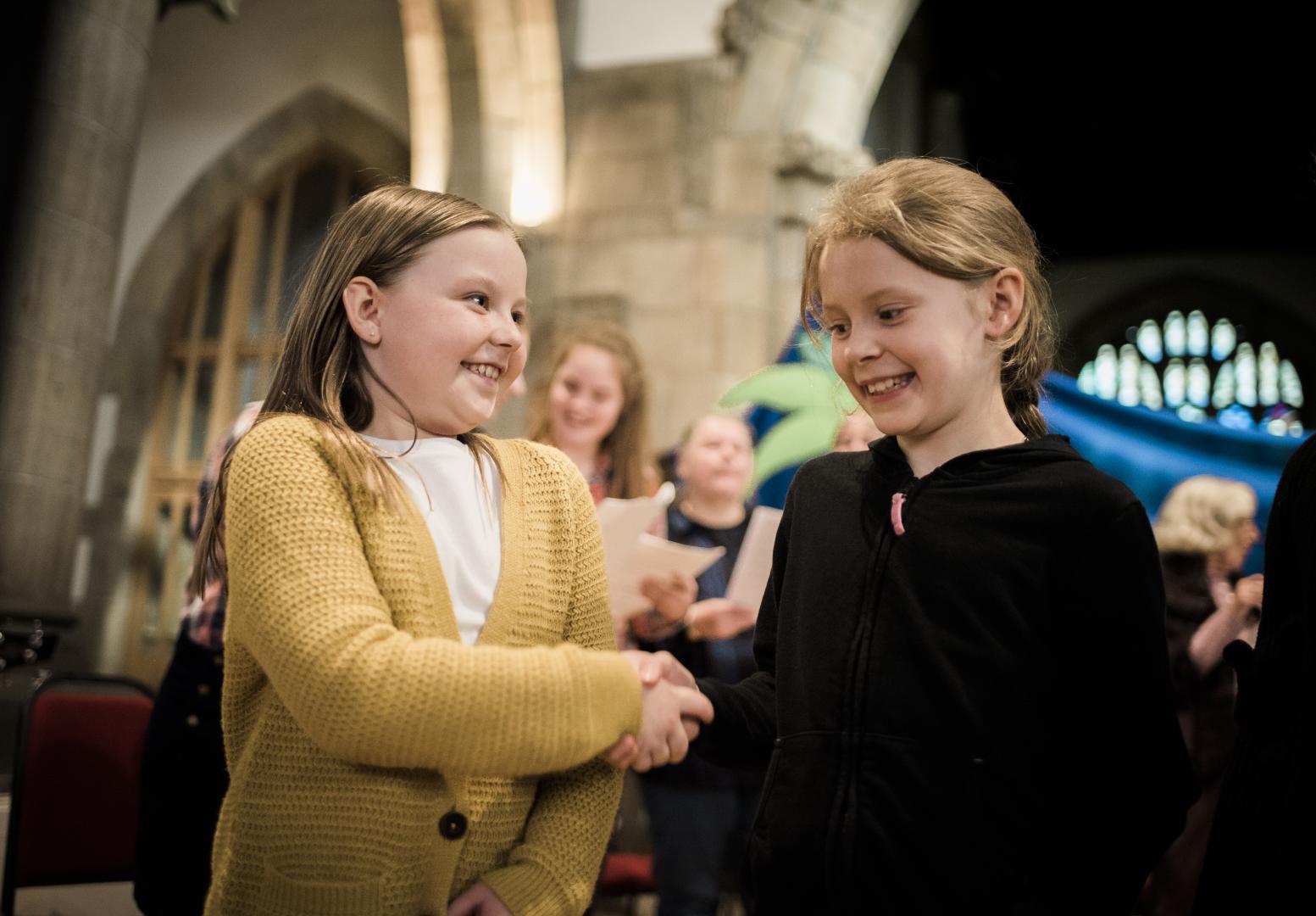 Primary pupils tell a biblical story of friendship and loyalty