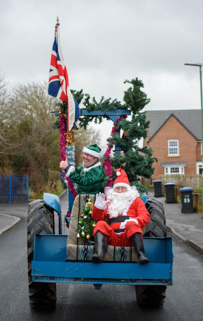 Super Santa arrives at Barney schools on a vintage tractor