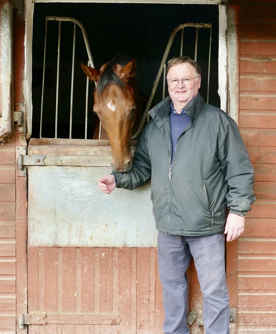 Trainer opens the stable door to show a thoroughbred level of care